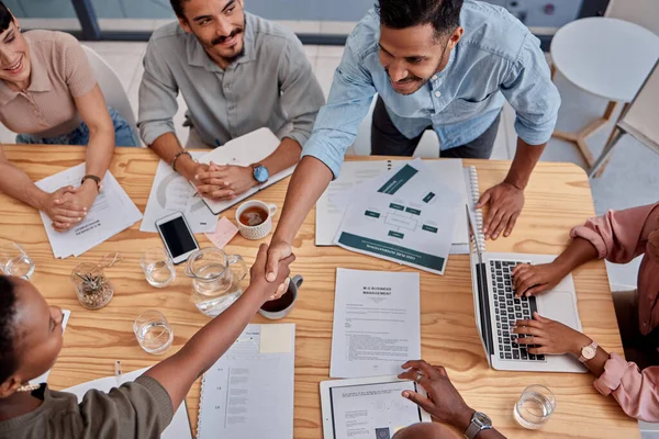 Good doing business with you. two businesspeople shaking hands at the office