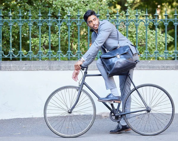Reduce your carbon footprint. a young businessman riding a bike in the city