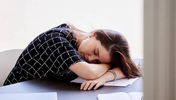 Ill just close my eyes for a bit. a young businesswoman taking a nap in her office