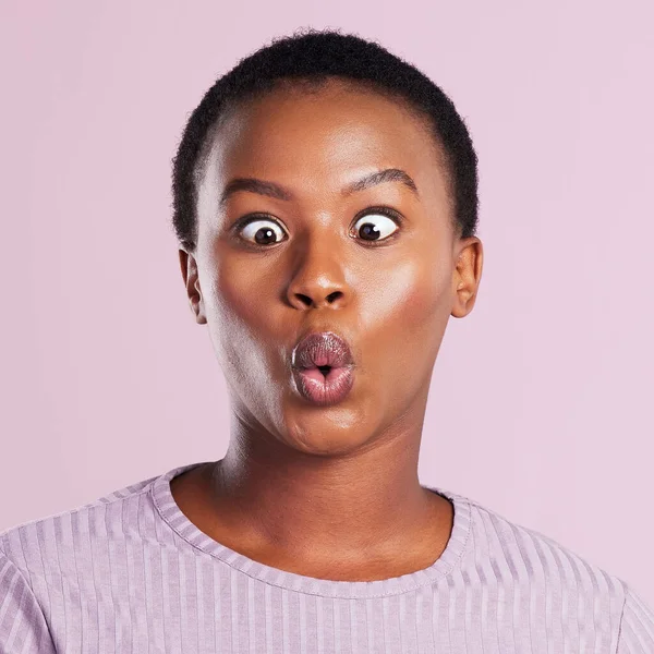 Embrace your silly side. Studio shot of a young woman making a silly face against a pink background