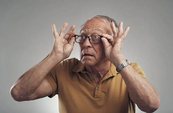New Specs Studio Shot Elderly Man Adjusting His Spectacles Grey — Zdjęcie stockowe