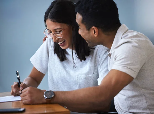 Your velvet touch sends me back to the moon. a young couple completing paperwork at an office