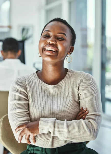 People will always doubt you until you prove them wrong. Portrait of a happy young businesswoman sitting in an office