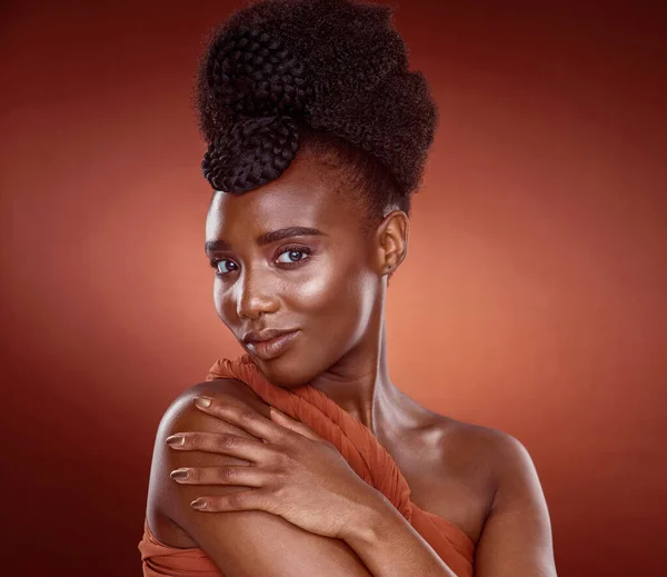 Its not about the brand, its about style. Cropped portrait of an attractive young woman posing in studio against a red background