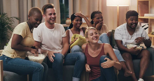 That scene was ridiculously funny. a group of a diverse group of friends relaxing in the lounge at home