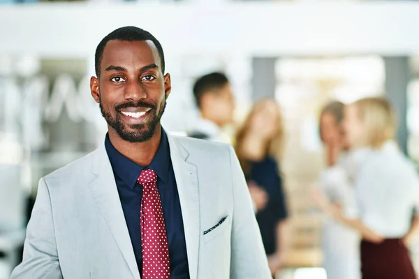 Manager, leader and boss standing with diverse team of executives in office background. Portrait of confident, successful or proud ceo with happy, smiling and cheerful face expression after a meeting.