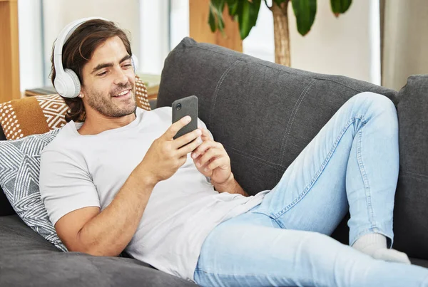 Wonder What Friends Young Man Lying His Sofa Using His — Stock Photo, Image