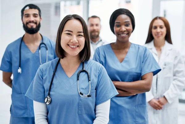 Here to help you take the path to improved health. Portrait of a group of medical practitioners standing together in a hospital