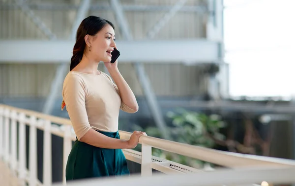 Developing customer relationships can be done by keeping communication channels open. a young businesswoman talking on a cellphone in an office