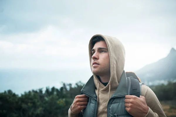 May your time in nature lead you to yourself. a young man hiking through the mountains