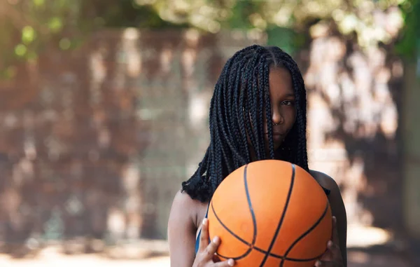 Guess the balls in my court. Cropped portrait of an attractive young female athlete standing on the basketball court