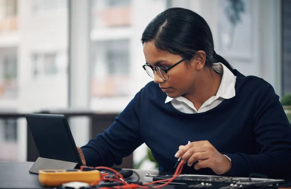 The best technology to fix any technology. a young technician using a digital tablet while repairing computer hardware