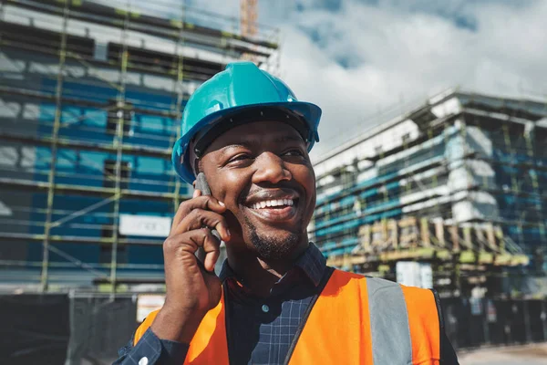 Making positive moves for a winning project. a young man using a smartphone while working at a construction site