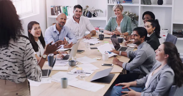 When we do good, were inspired to do even better. a group of businesspeople having a meeting in a modern office