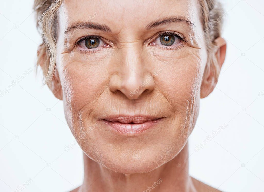 Our skin ages as we age. a beautiful mature woman posing against a white background