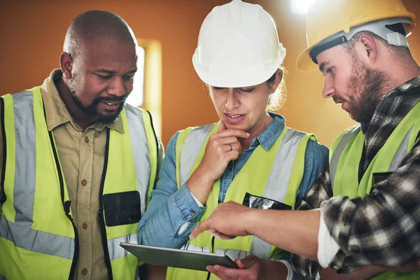 Cutting Edge Tech Quality Construction Group Builders Using Digital Tablet — Photo