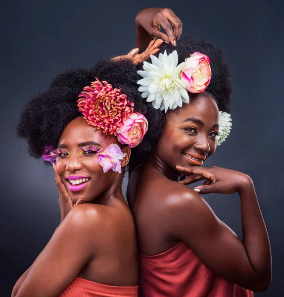 Theres nothing more beautiful than the smile on your face. two beautiful women posing together with flowers in their hair