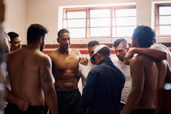 Forget sports team, theyre a family. a rugby coach addressing his team players in a locker room