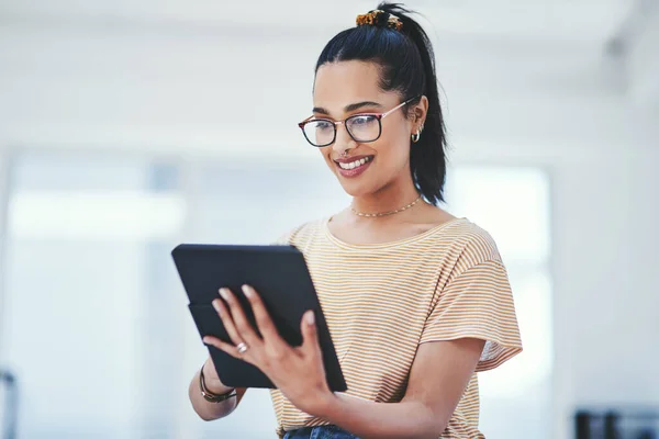 To stay relevant, you need to adapt to modern changes. a young designer using a digital tablet in an office