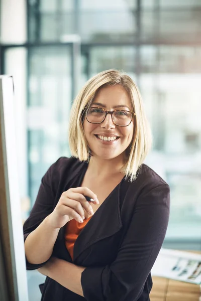 Happy, professional and corporate business woman writing creative ideas, taking notes and brainstorming alone in an office at work. Portrait of a smiling employee planning and designing a strategy.