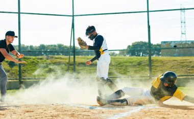 The dust is his playground. Full length shot of a young baseball player reaching base during a game on the field clipart