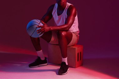 Theres no off season. Red filtered shot of an unrecognizable sportsman posing with a basketball in the studio