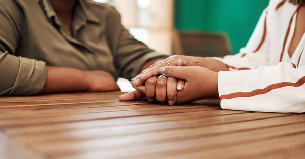 Best friends will always be there for you. two unrecognisable women holding hands at cafe table