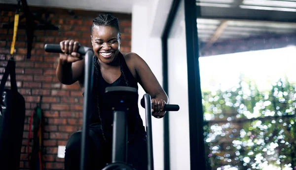 Push it to the limit. an attractive young female athlete working out on an elliptical machine in the gym