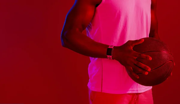 Keep practicing until you get it right. Red filtered shot of an unrecognizable sportsman posing with a basketball in the studio