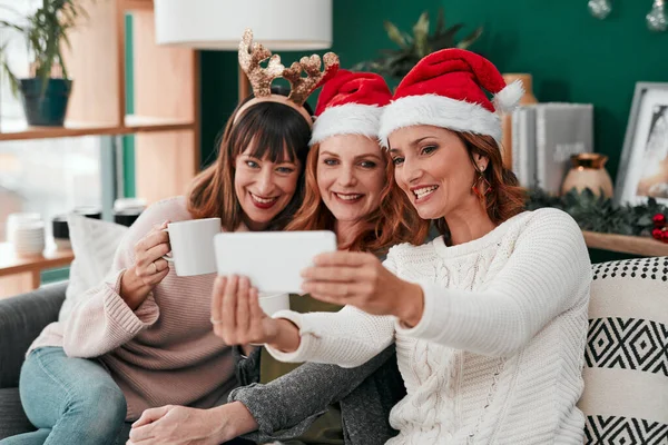 Could it be better. three attractive women taking Christmas selfies together at home