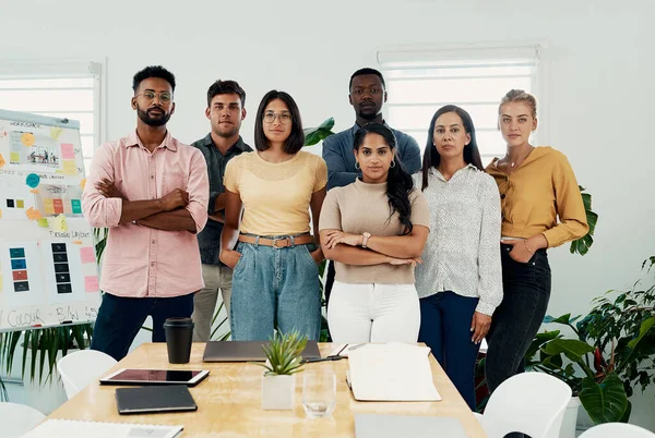 Watch out world. Cropped portrait of a diverse group businesspeople standing together after a successful discussion in the office