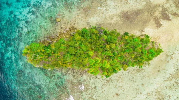 Islands are the perfect holiday destination. High angle shot of a little islet in the middle of the wonderful Raja Ampat Islands in Indonesia