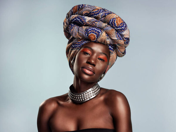 Radiance is the essence of beauty. Studio shot of a beautiful young woman wearing a traditional African head wrap against a grey background