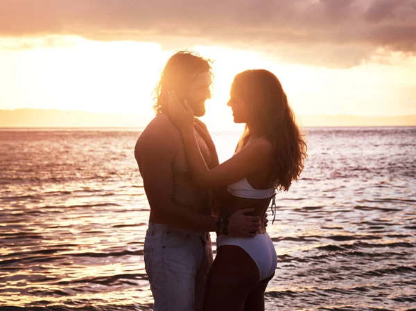 I get lost in your eyes and lost in your smile. an affectionate young couple spending quality time together at the beach