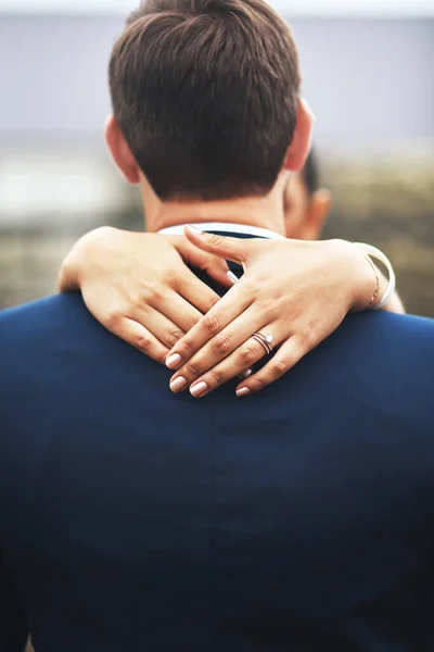 Ill never turn my back on her and our marriage. Rearview shot of an unrecognizable newlywed young couple hugging and embracing on their wedding day