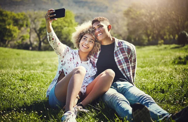 Im making this one my profile picture. a young couple taking a selfie while spending the day at the park