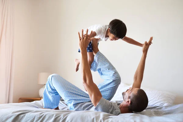 Have Much Fun Together Cheerful Father Son Playing Together Bedroom — Stock fotografie