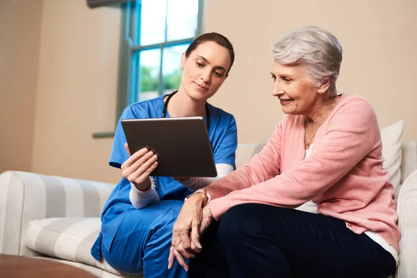 Wanted Something Nice You Female Nurse Showing Her Senior Patient — Fotografia de Stock