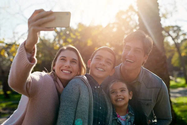 Our family moments become our greatest memories. a happy young family taking a selfie together in the park