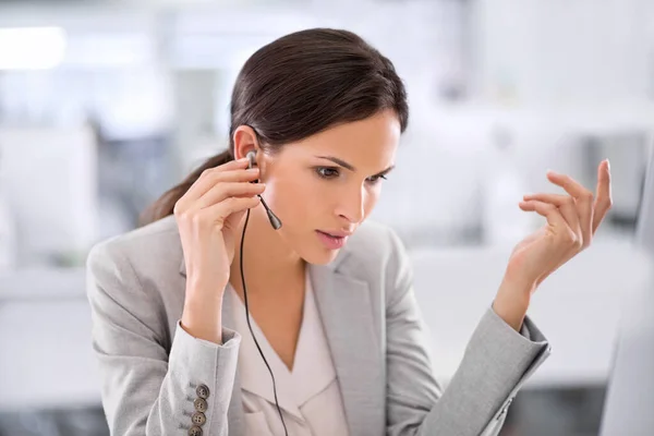 Call center agent helping a client via phone call to give them good customer service and care. Professional consultant employee at contact support listening to a person via her headset at work desk.