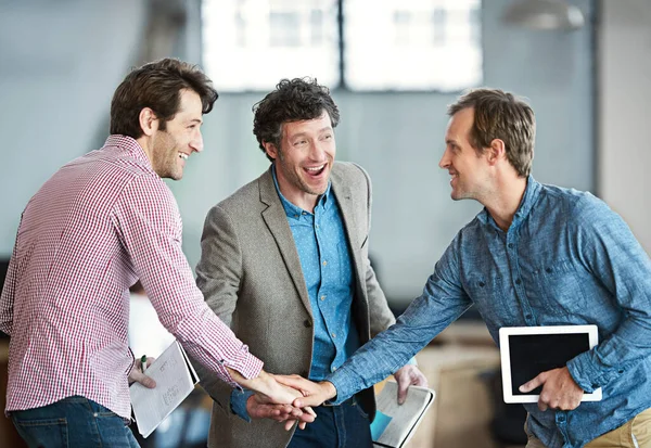 Hands in a huddle as a business man and his colleagues or coworkers cheer and celebrate success, a win or career achievement. Cheering and celebrating victory as a team or group in their work office.