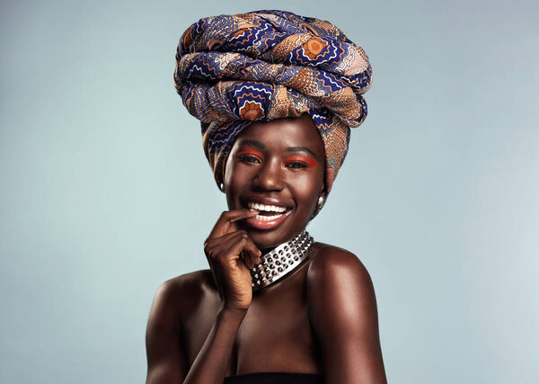 Ive got a different print for every occasion. Studio shot of a beautiful young woman wearing a traditional African head wrap against a grey background