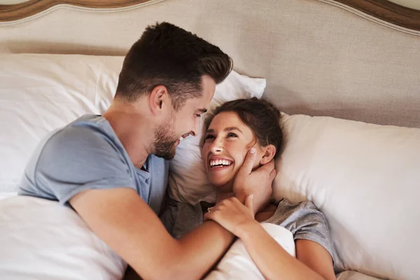 Loving you is the most precious feeling in the world. an affectionate young couple spending some quality time together in their bedroom at home