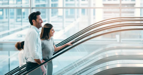 Theyre Excited Working Together Two Young Businesspeople Going Escalator Modern — Zdjęcie stockowe