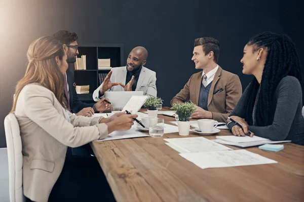 Meet and get business moving. a group of young businesspeople having a meeting in a modern office