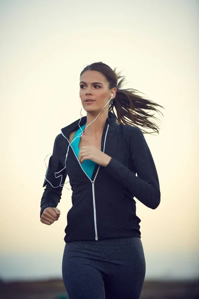 Nothing clears your head better than a good run. a sporty young woman exercising outdoors