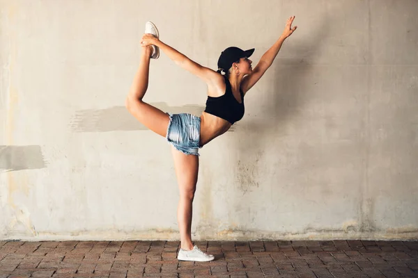 Shes got perfect form. an attractive young female street dancer practising out in the city