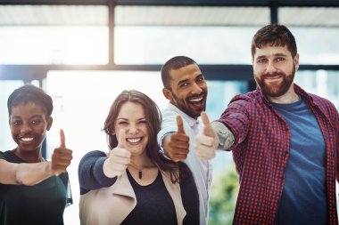 Teamwork, support and trust with a thumbs up from happy colleagues collaborating. Excited partners uniting, showing trust and success with a winning gesture. Community working together towards a goal.