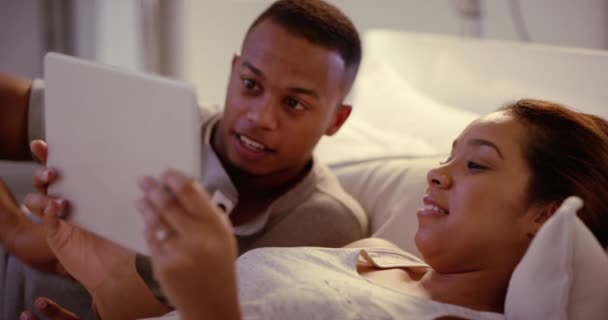 Couple Browsing Tablet Talking Watching Movies Series Online Together Couch — Stockvideo