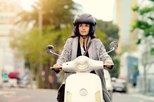 Always be mindful where each journey leads to. an attractive young woman riding around the city on her scooter